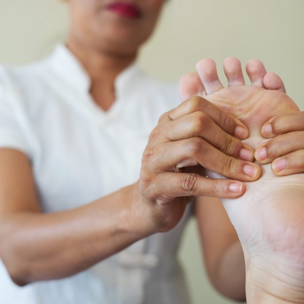 Close-up of woman doing foot massage at spa. Close-up of woman doing foot massage at spa.